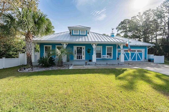 view of front of property with a front lawn, covered porch, and a garage