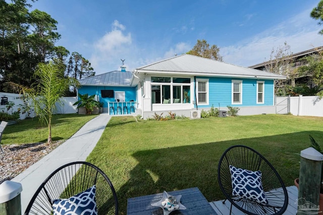 rear view of property featuring exterior bar and a yard