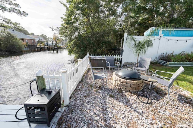 view of yard featuring a fire pit and a water view