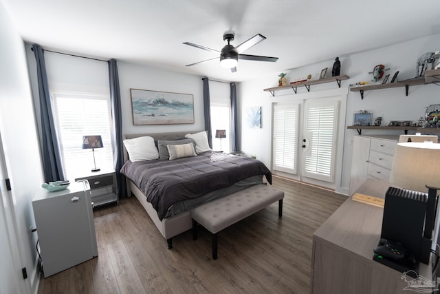 bedroom featuring access to outside, multiple windows, ceiling fan, and dark hardwood / wood-style floors