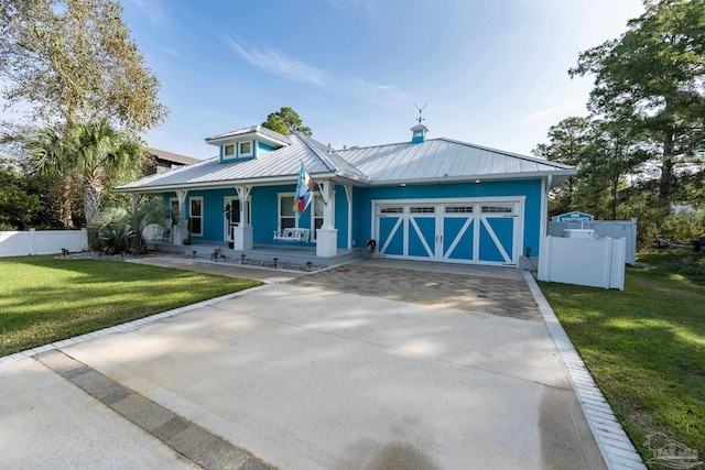 view of front of house with a porch, a garage, and a front lawn