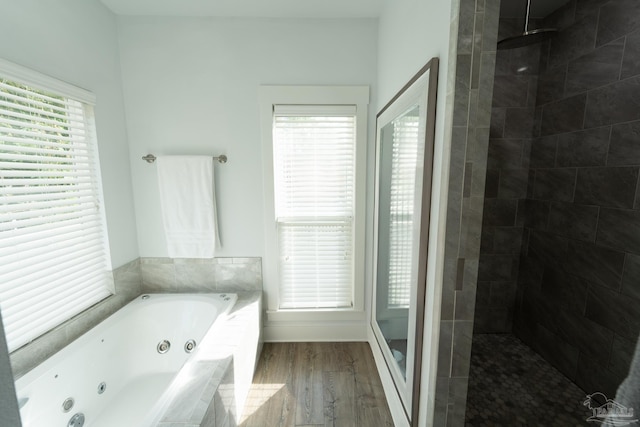 bathroom with hardwood / wood-style flooring, a wealth of natural light, and independent shower and bath