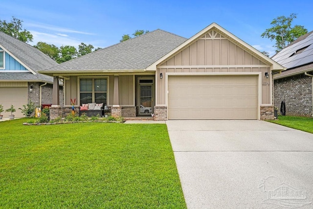 craftsman-style house featuring board and batten siding, covered porch, a front lawn, concrete driveway, and an attached garage