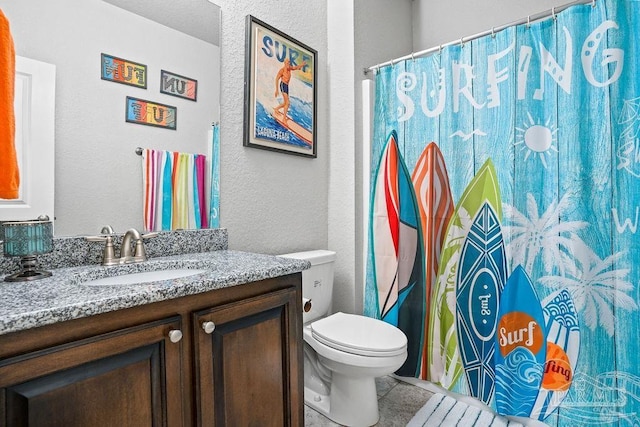 full bathroom with a textured wall, toilet, vanity, tile patterned floors, and curtained shower
