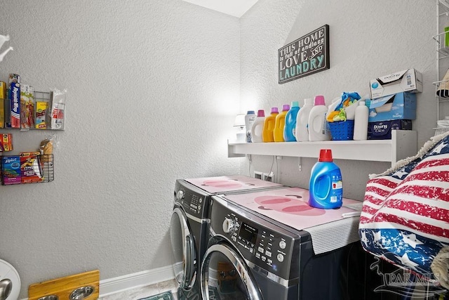 laundry area featuring washer and dryer and baseboards