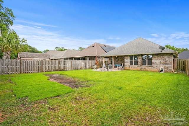 rear view of property with a patio area, brick siding, and a shingled roof