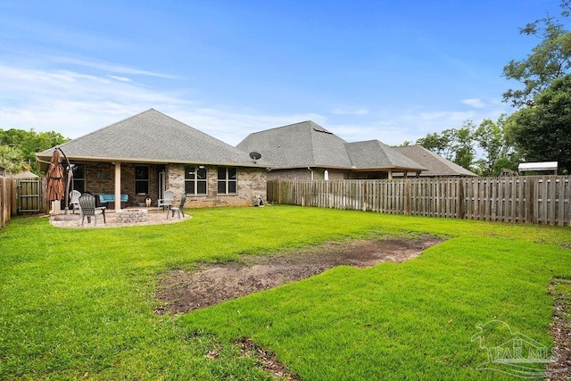 rear view of property featuring an outdoor fire pit, a patio area, roof with shingles, and brick siding