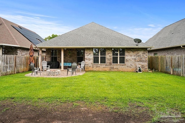 back of house with a fire pit, a patio, brick siding, and roof with shingles