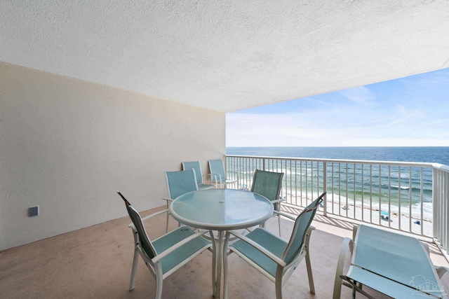 balcony with a beach view and a water view