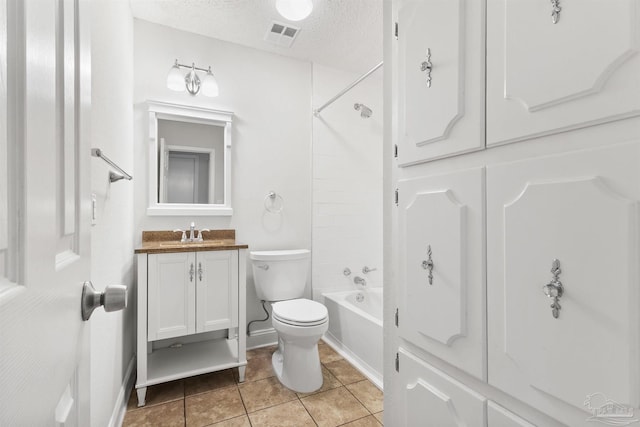 bathroom with a textured ceiling, washtub / shower combination, toilet, tile patterned floors, and vanity