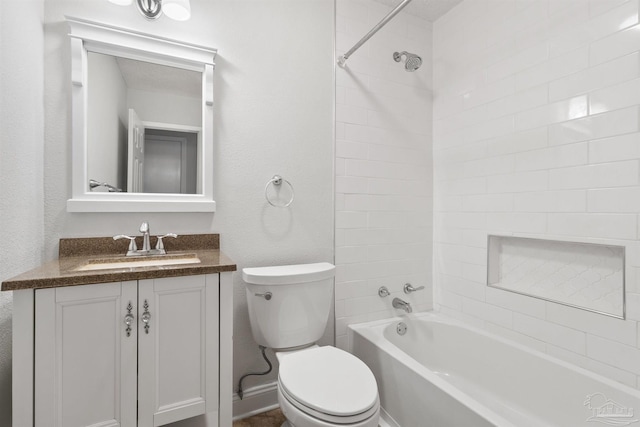 bathroom featuring toilet, vanity, and shower / tub combination
