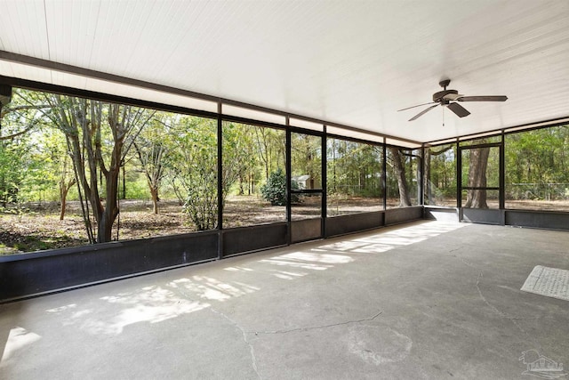 unfurnished sunroom featuring a ceiling fan
