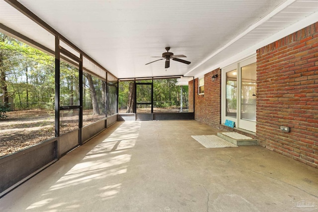 unfurnished sunroom with a healthy amount of sunlight and a ceiling fan