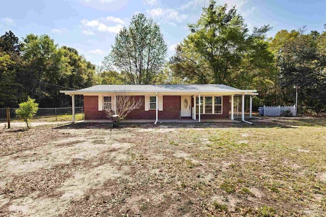 single story home with brick siding and fence