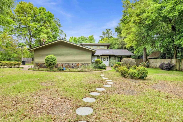 exterior space with fence and a front lawn