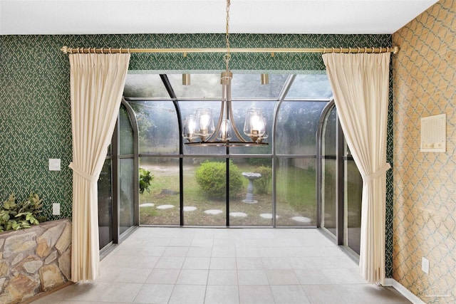unfurnished sunroom featuring a notable chandelier and plenty of natural light