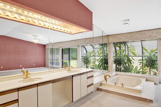 full bathroom with visible vents, a whirlpool tub, a sink, and double vanity