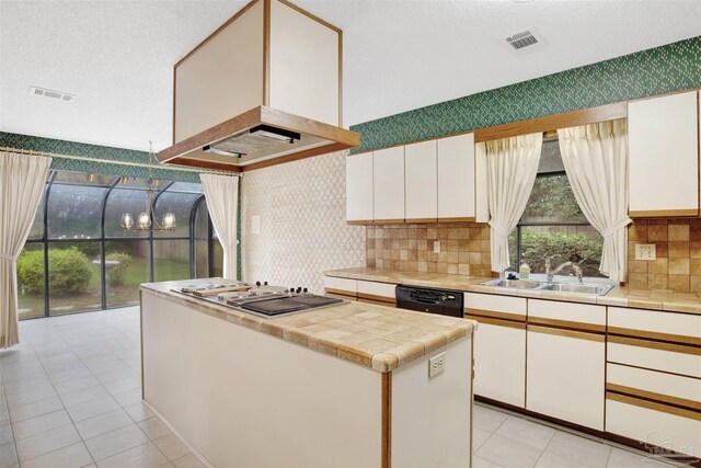 kitchen featuring white cabinets, dishwasher, visible vents, and a sink
