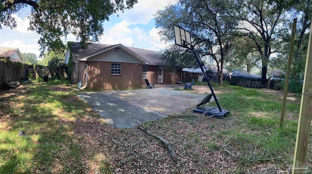 rear view of property featuring a patio and a yard