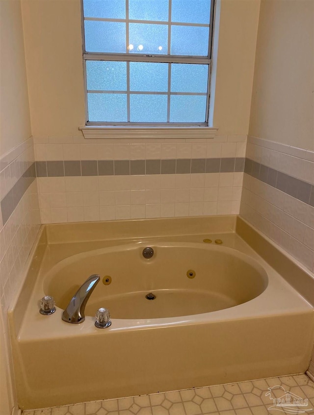 bathroom with a bathing tub and tile patterned floors