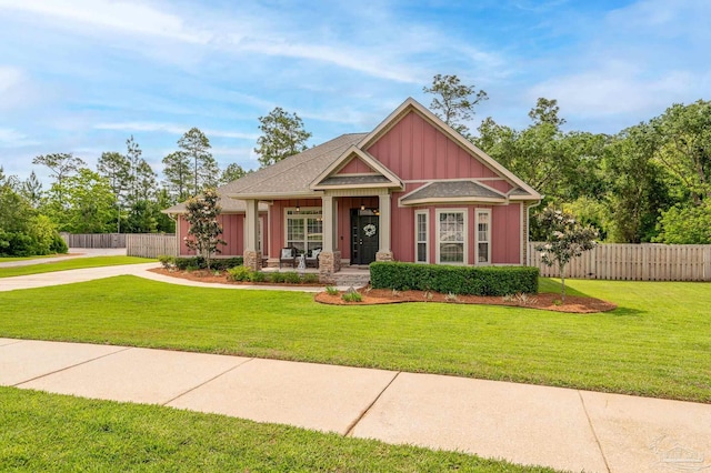 8847 Salt Grass Dr, Pensacola, FL 32526 - craftsman-style house featuring board and batten siding, fence, covered porch, and a front yard