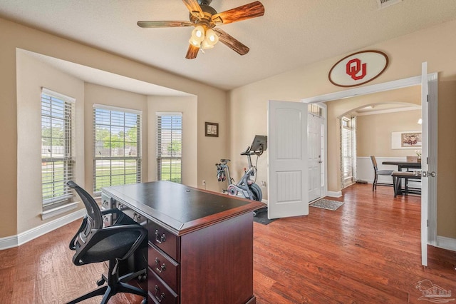8847 Salt Grass Dr, Pensacola, FL 32526 - office area with arched walkways, baseboards, a ceiling fan, and wood finished floors