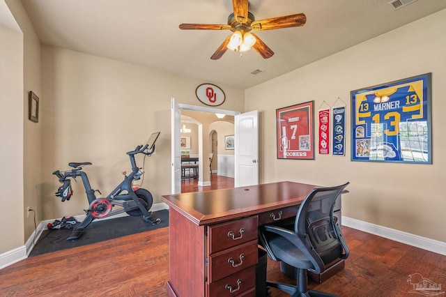 8847 Salt Grass Dr, Pensacola, FL 32526 - office with visible vents, baseboards, dark wood-style floors, arched walkways, and a ceiling fan