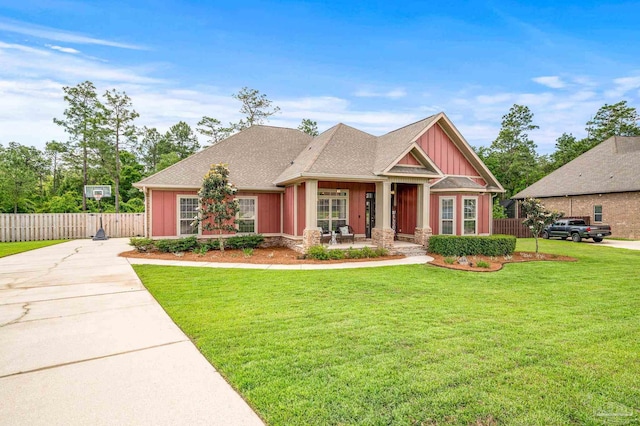 8847 Salt Grass Dr, Pensacola, FL 32526 - craftsman house featuring a porch, a front lawn, board and batten siding, and fence