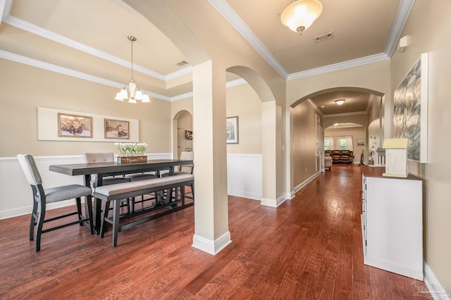 8847 Salt Grass Dr, Pensacola, FL 32526 - interior space with visible vents, crown molding, a chandelier, arched walkways, and dark wood finished floors