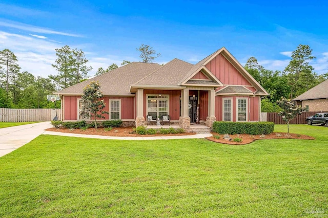 8847 Salt Grass Dr, Pensacola, FL 32526 - craftsman-style house with board and batten siding, fence, a porch, and a front lawn