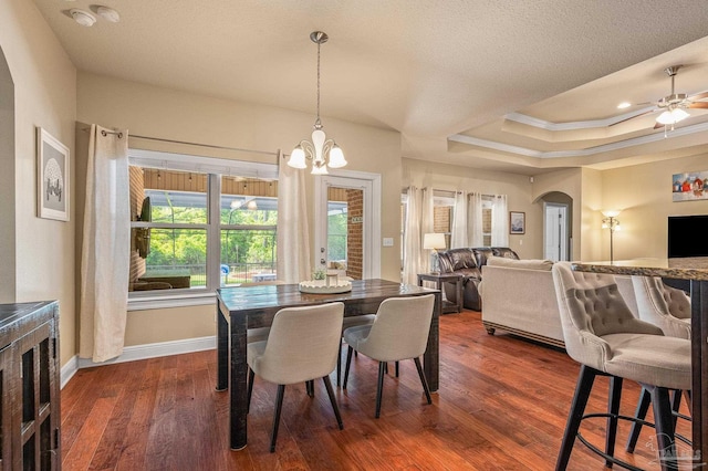 8847 Salt Grass Dr, Pensacola, FL 32526 - dining room with dark wood-style flooring, arched walkways, baseboards, a raised ceiling, and ornamental molding