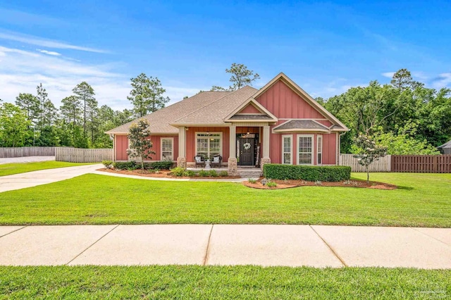8847 Salt Grass Dr, Pensacola, FL 32526 - craftsman-style home featuring board and batten siding, fence, covered porch, and a front yard