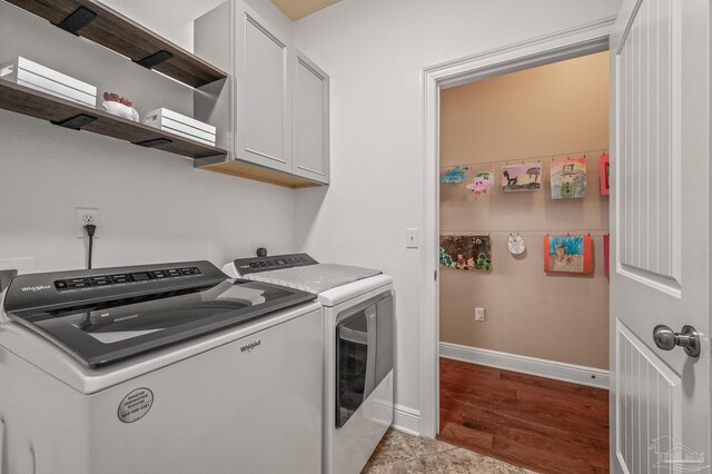 8847 Salt Grass Dr, Pensacola, FL 32526 - clothes washing area featuring baseboards, cabinet space, and washer and dryer