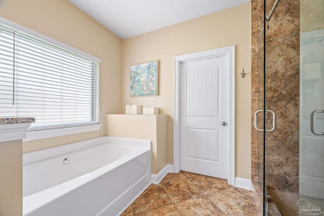 8847 Salt Grass Dr, Pensacola, FL 32526 - full bathroom with baseboards, a shower stall, and a garden tub