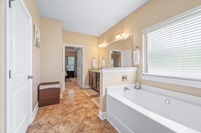 8847 Salt Grass Dr, Pensacola, FL 32526 - full bathroom with baseboards, a wealth of natural light, a bath, and vanity