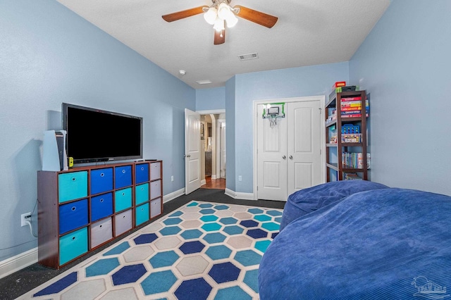 8847 Salt Grass Dr, Pensacola, FL 32526 - bedroom with a ceiling fan, a textured ceiling, visible vents, baseboards, and a closet
