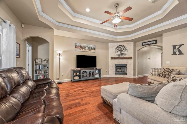 8847 Salt Grass Dr, Pensacola, FL 32526 - living room with a ceiling fan, arched walkways, wood finished floors, ornamental molding, and a tray ceiling