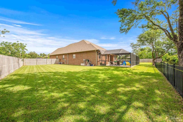 8847 Salt Grass Dr, Pensacola, FL 32526 - view of yard featuring a fenced backyard and a lanai