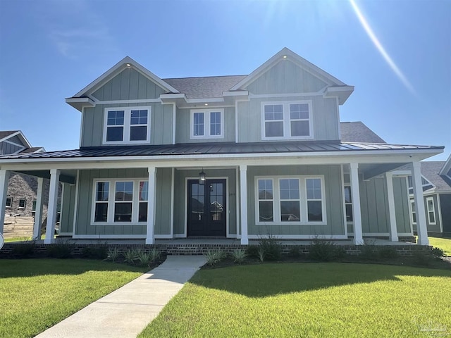 view of front of property with a front yard and covered porch