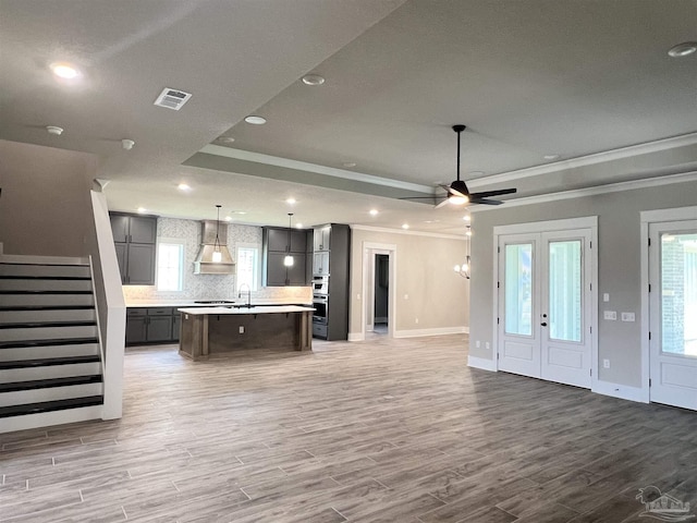 2440 Meeting St, Cantonment, FL 32533 - unfurnished living room with sink, hardwood / wood-style flooring, ornamental molding, and a raised ceiling