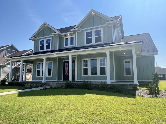 view of front of home featuring covered porch and a front lawn