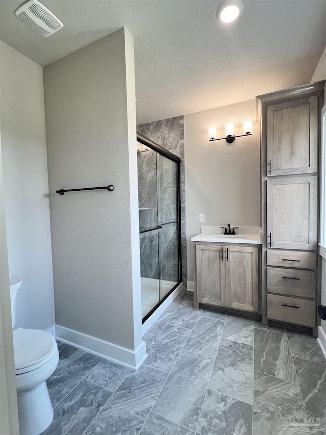 2440 Meeting St, Cantonment, FL 32533 - bathroom with vanity, toilet, a shower with door, and a textured ceiling
