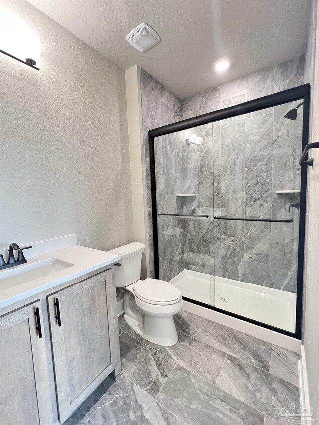 2440 Meeting St, Cantonment, FL 32533 - bathroom with vanity, a textured ceiling, a shower with door, and toilet