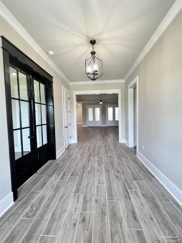 2440 Meeting St, Cantonment, FL 32533 - unfurnished living room with crown molding, an inviting chandelier, and french doors