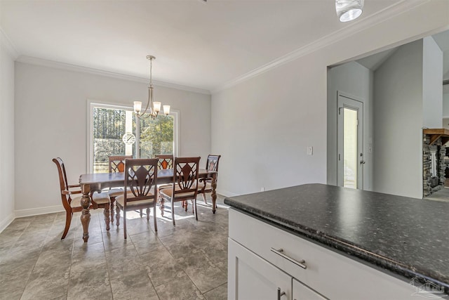 dining space featuring crown molding, a fireplace, and an inviting chandelier