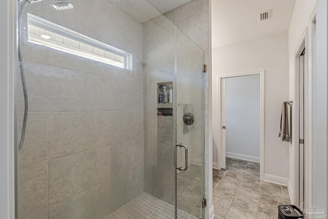 bathroom with a shower with door