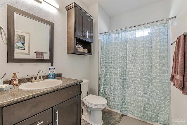 bathroom featuring a shower with curtain, tile patterned flooring, vanity, and toilet