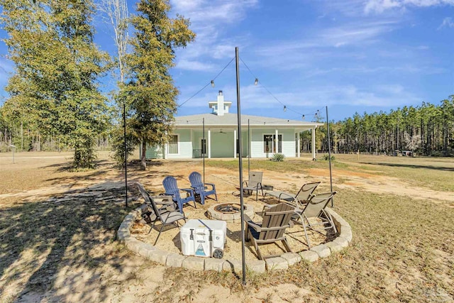 back of house with an outdoor fire pit