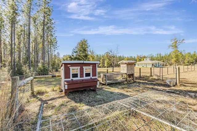 view of yard featuring a storage unit and a rural view