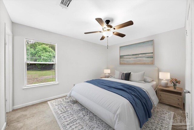 bedroom with baseboards, light colored carpet, and ceiling fan